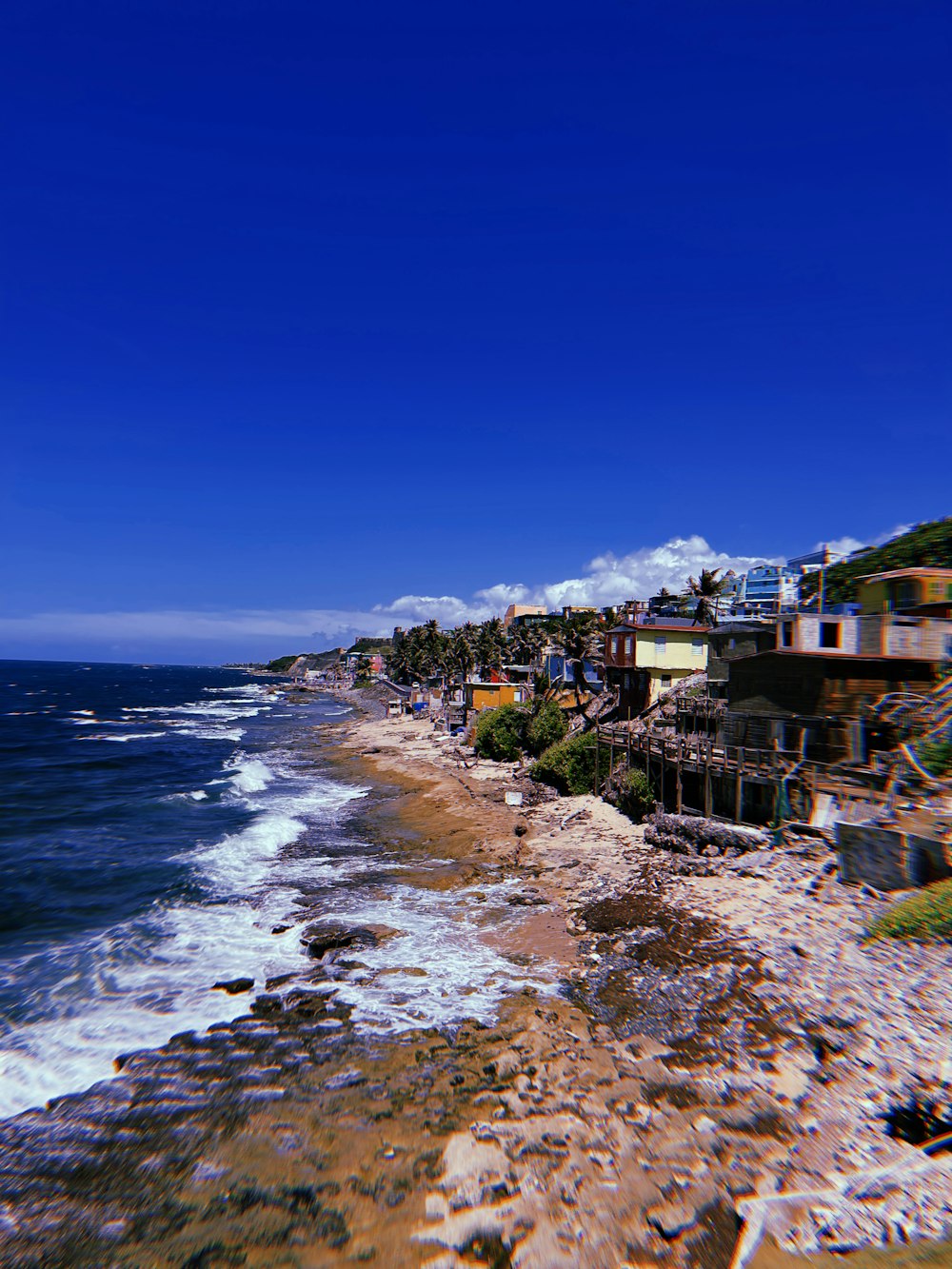 a beach with houses along it