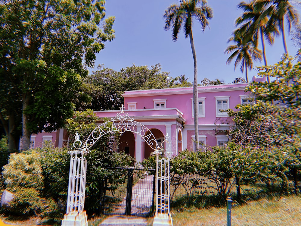 a pink house with a gate