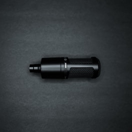 Close-up of a sleek microphone with a modern design on a minimalist background