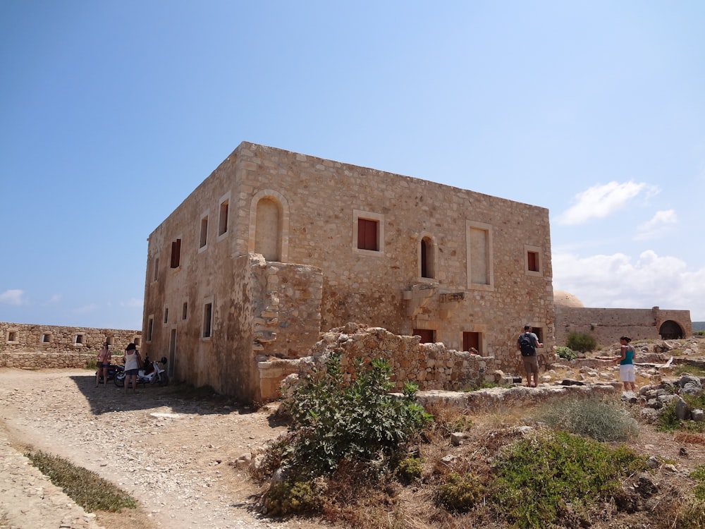 a stone building with people standing outside