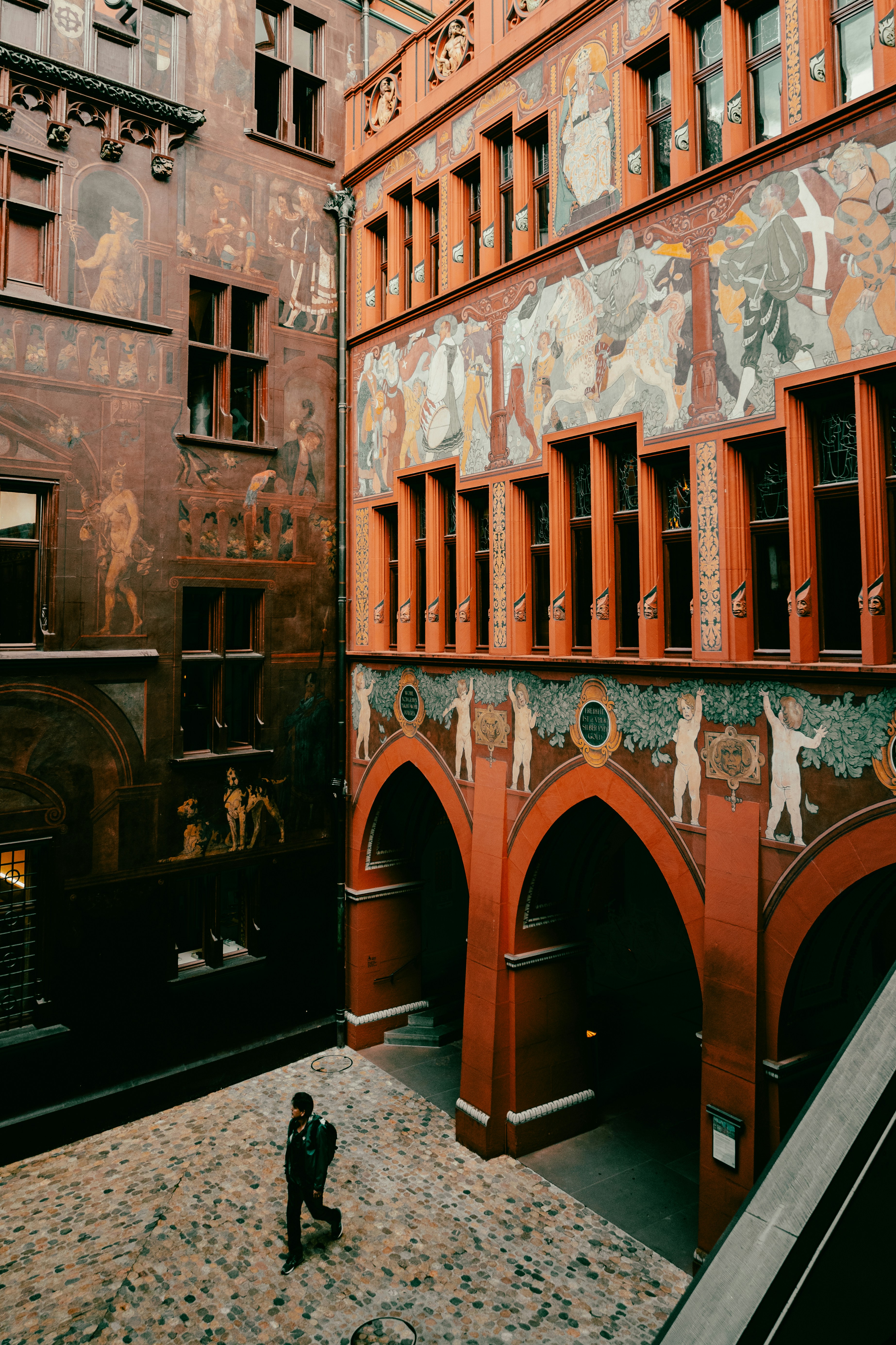 a person standing in front of a building with graffiti on it