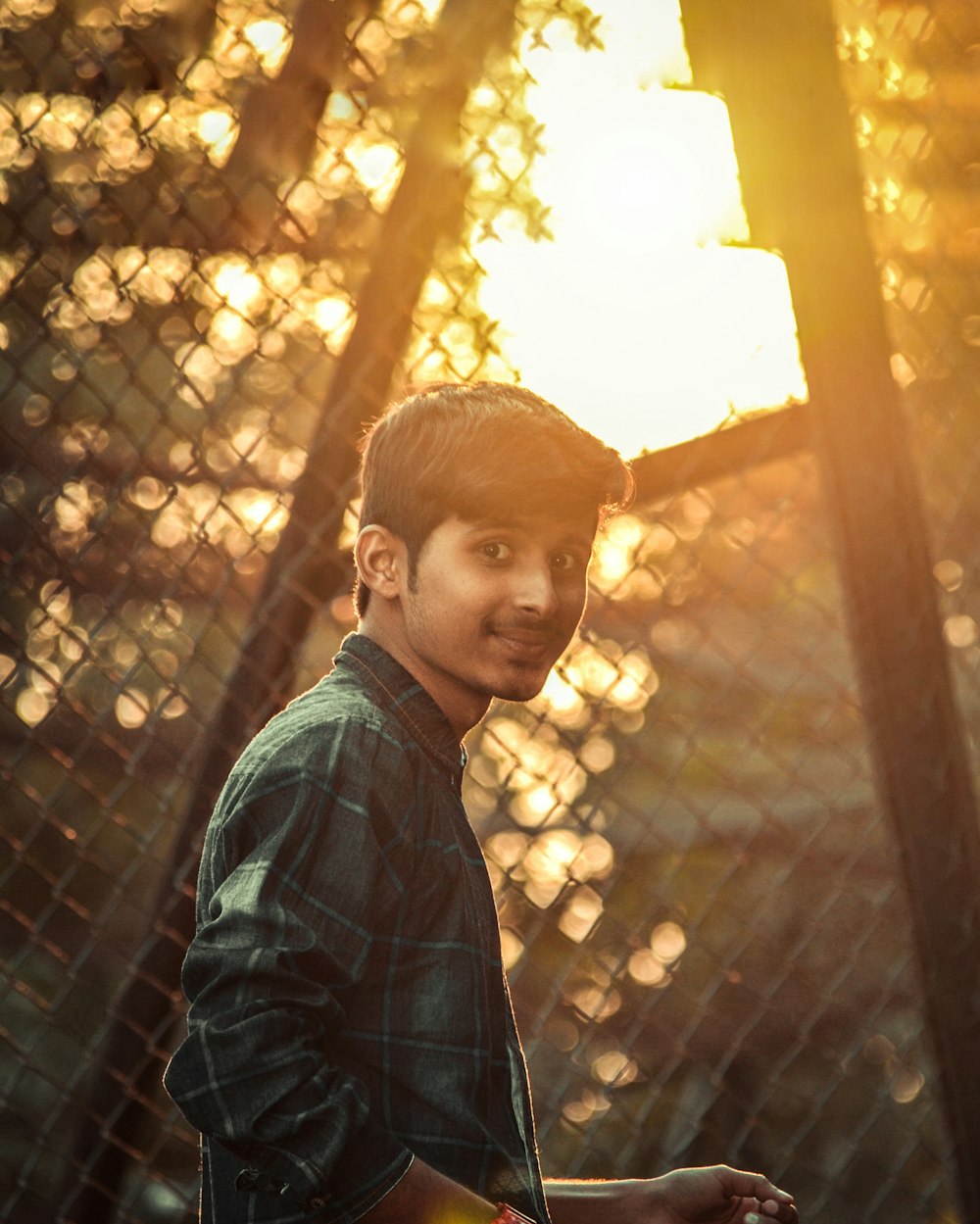 a person standing in front of a tree with lights