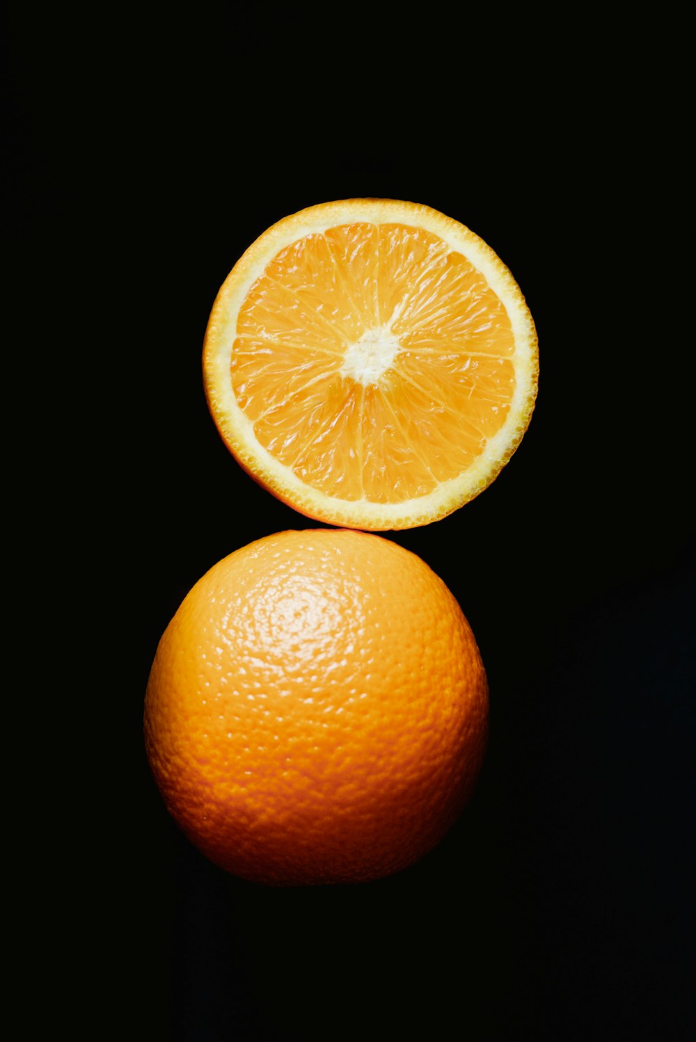 a lemon next to a whole orange