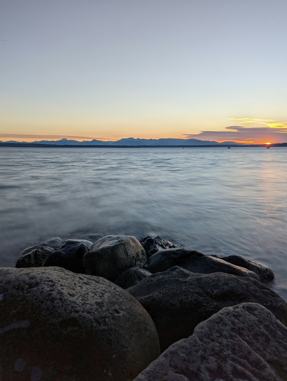 a rocky beach with a sunset