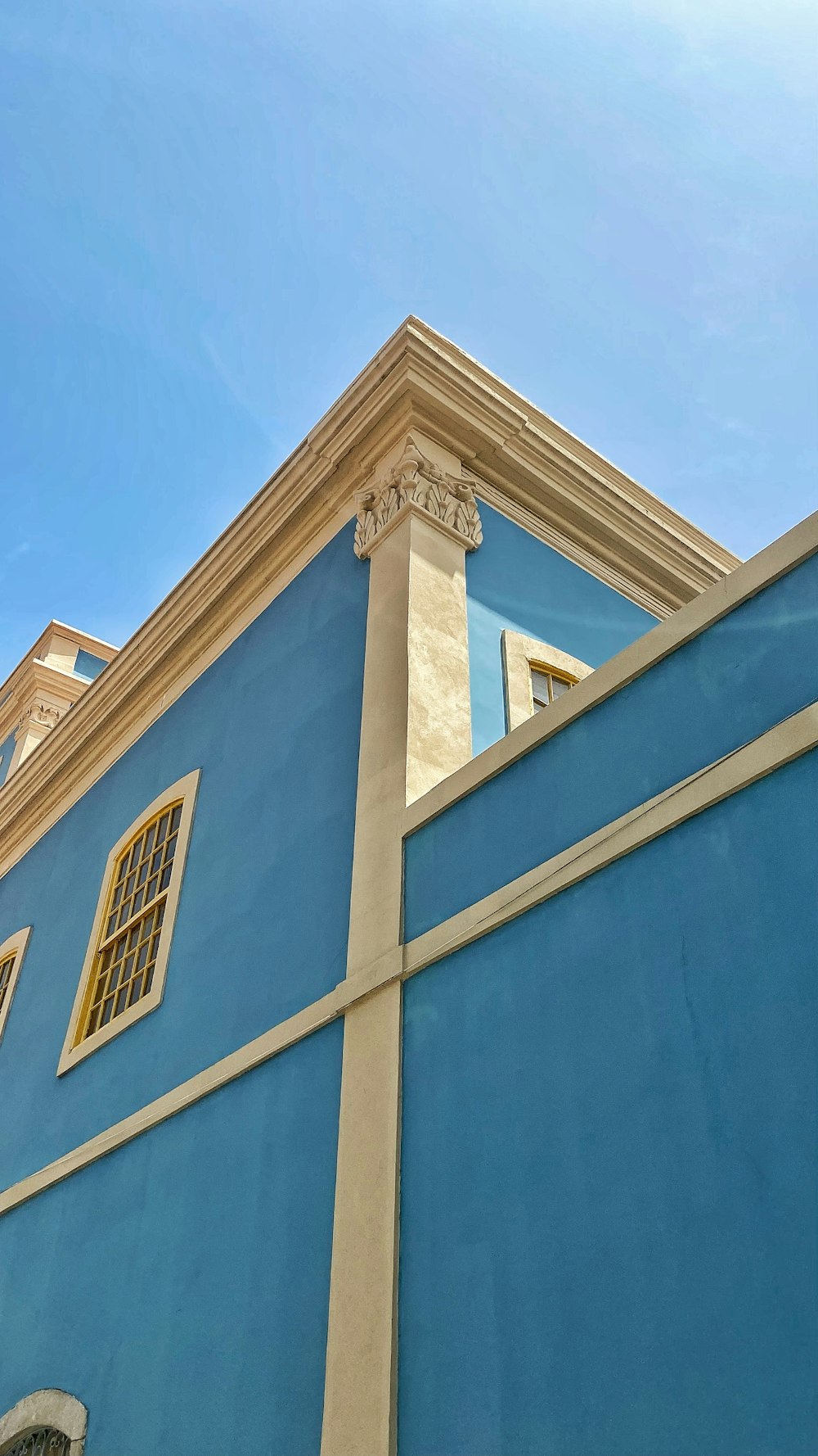 a blue building with a white roof