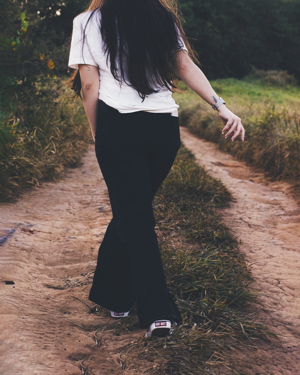 a person walking on a dirt path