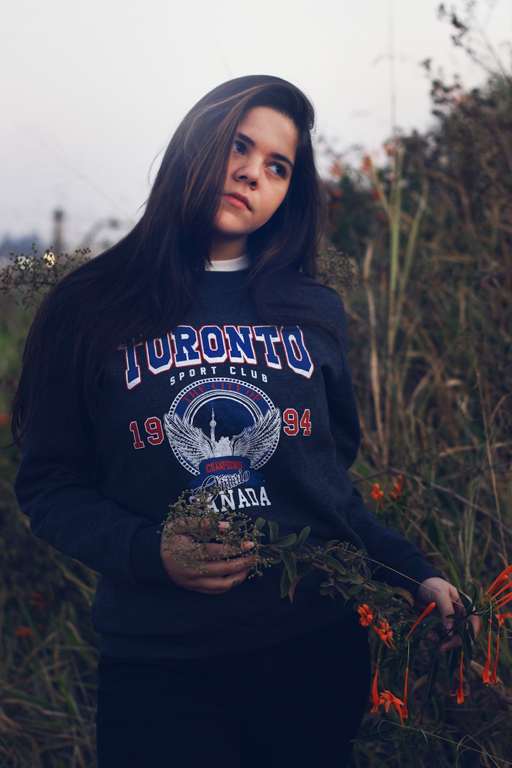 a woman holding a plant