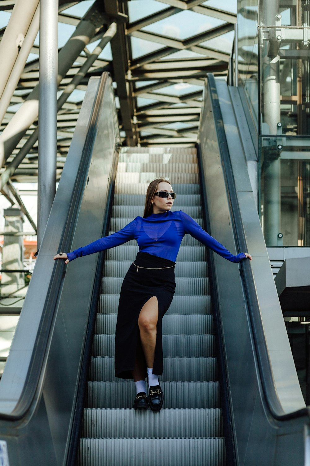 a woman standing on a metal staircase