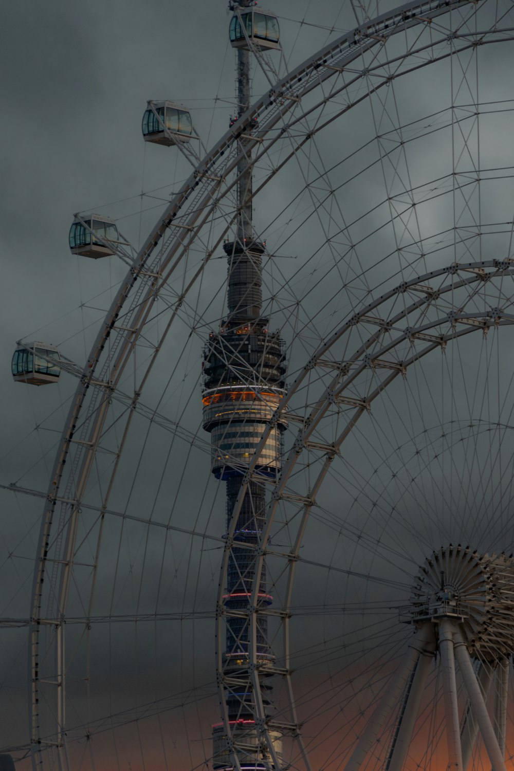 a ferris wheel with a cloudy sky