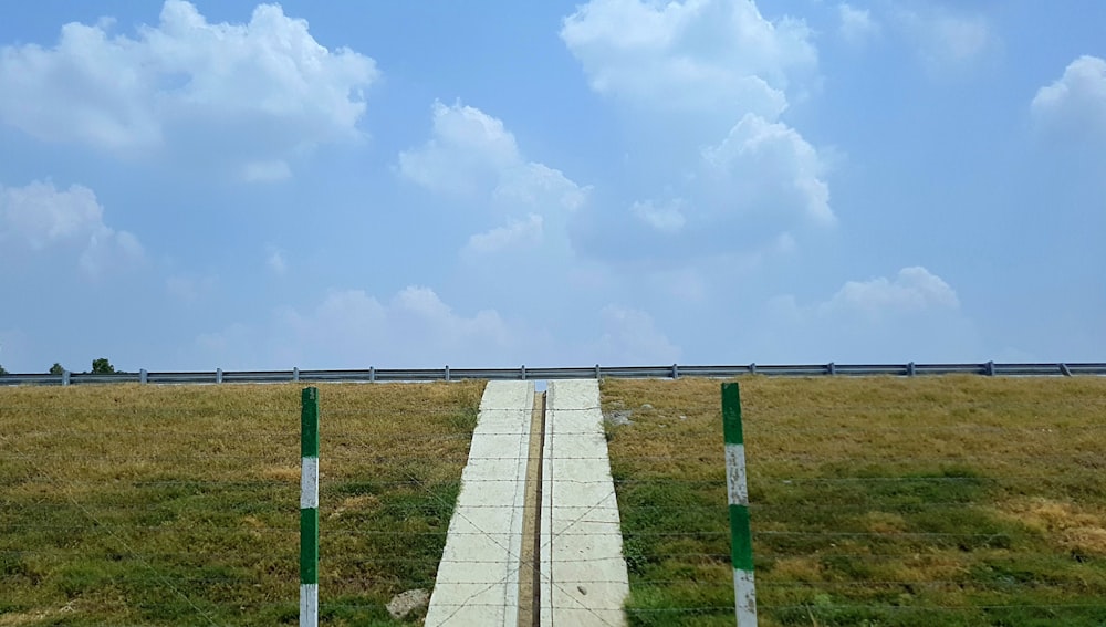 a concrete walkway in a field