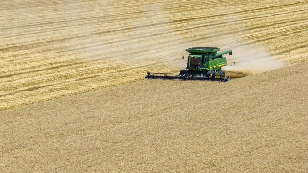 a green tractor in a field