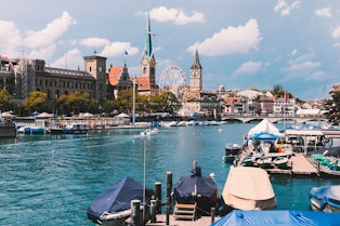 a body of water with boats and buildings in the background