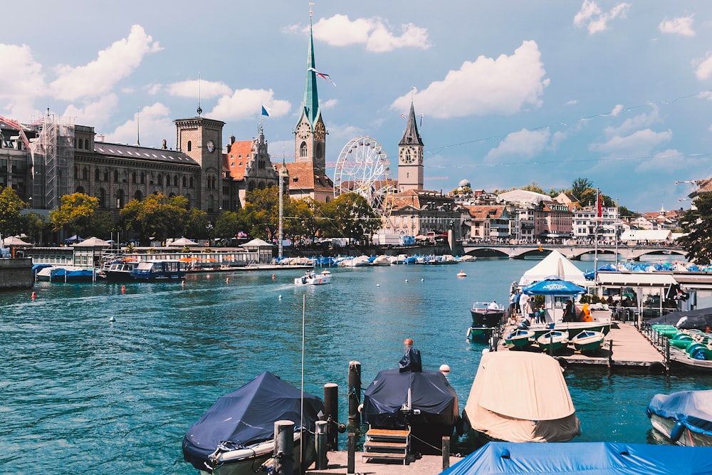 a body of water with boats and buildings in the background