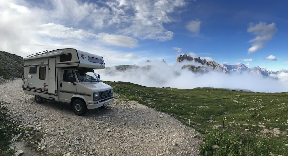 a white rv on a dirt road