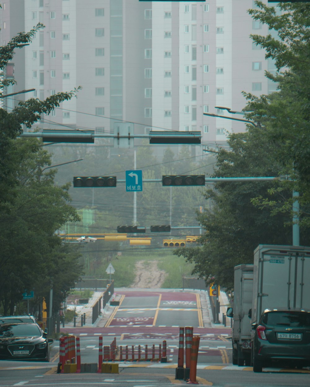 a street with cars and trees