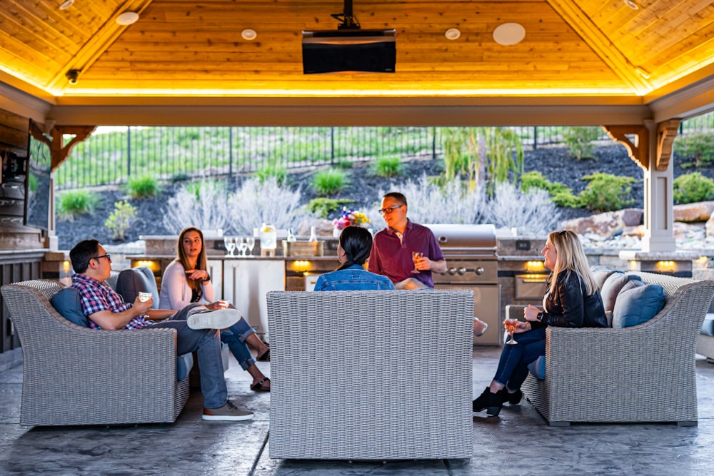 a group of people sitting in a room with a view of a city