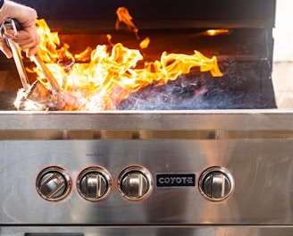 a person putting food in a grill