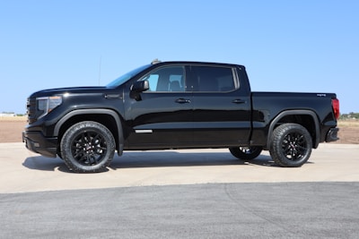 a black truck parked on a road