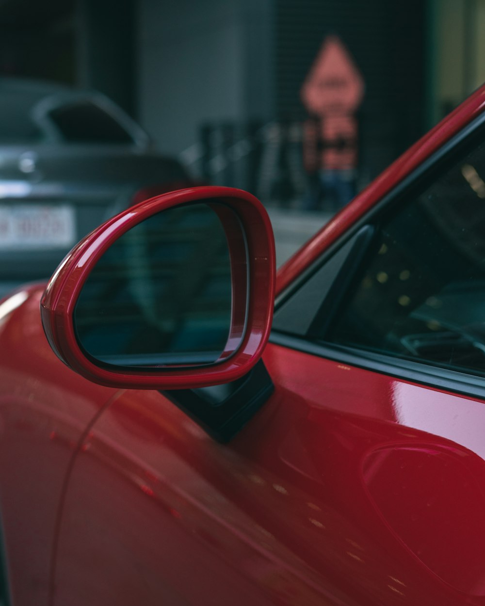 a red car with a man's face on the side