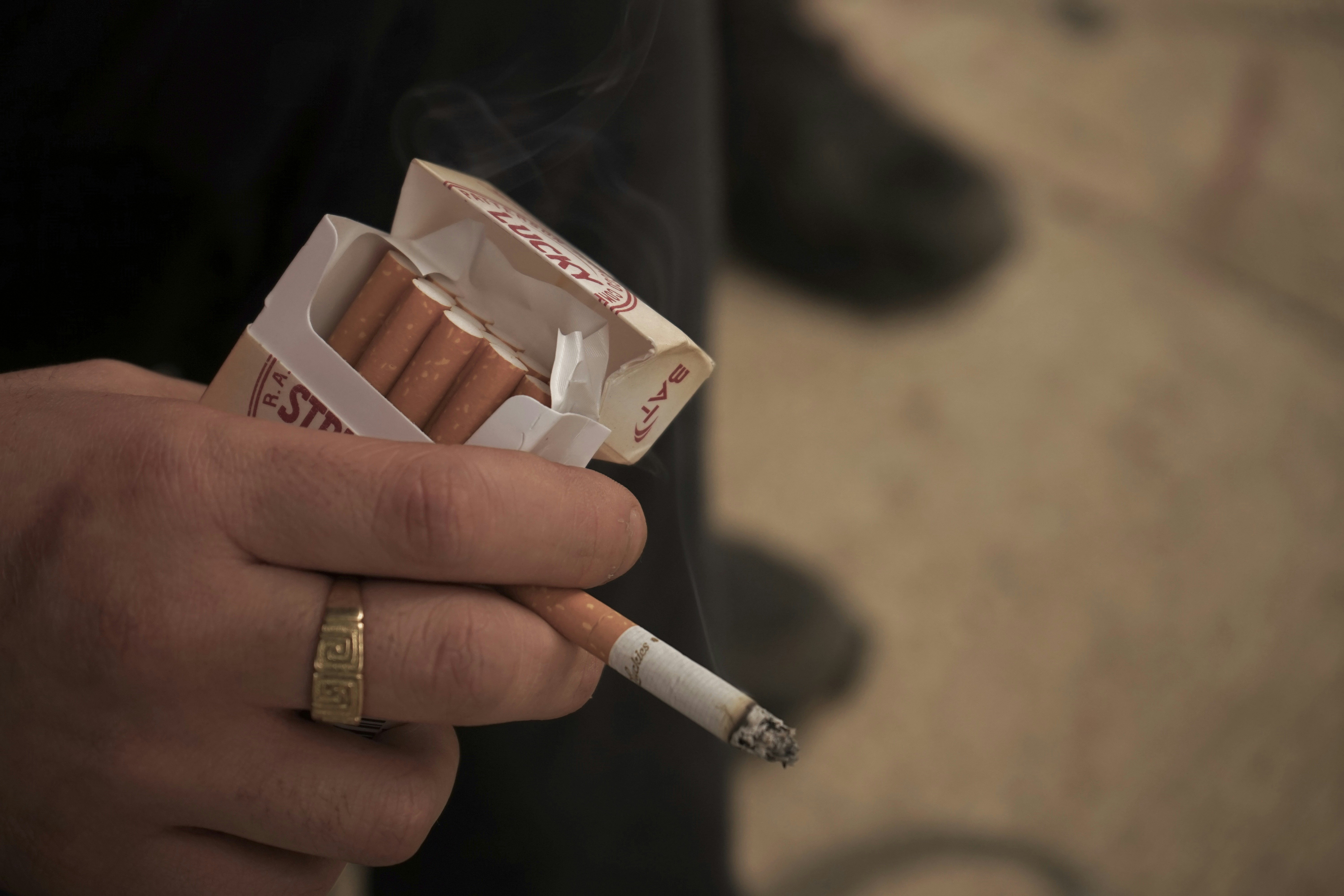 a hand holding a cigarette