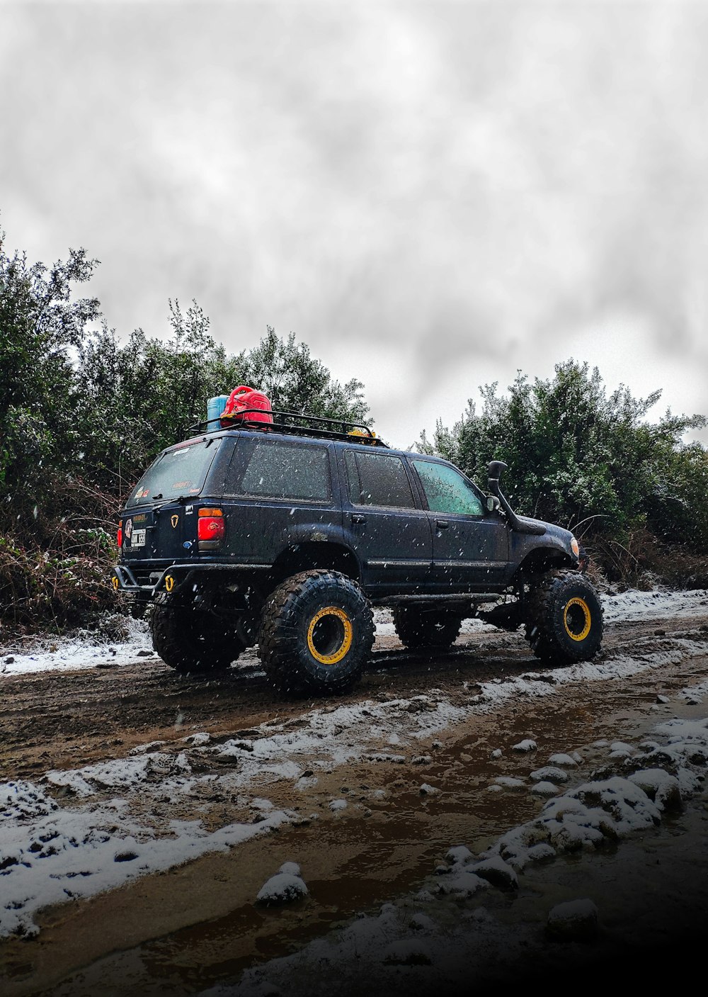 a black truck with a red hat on the back