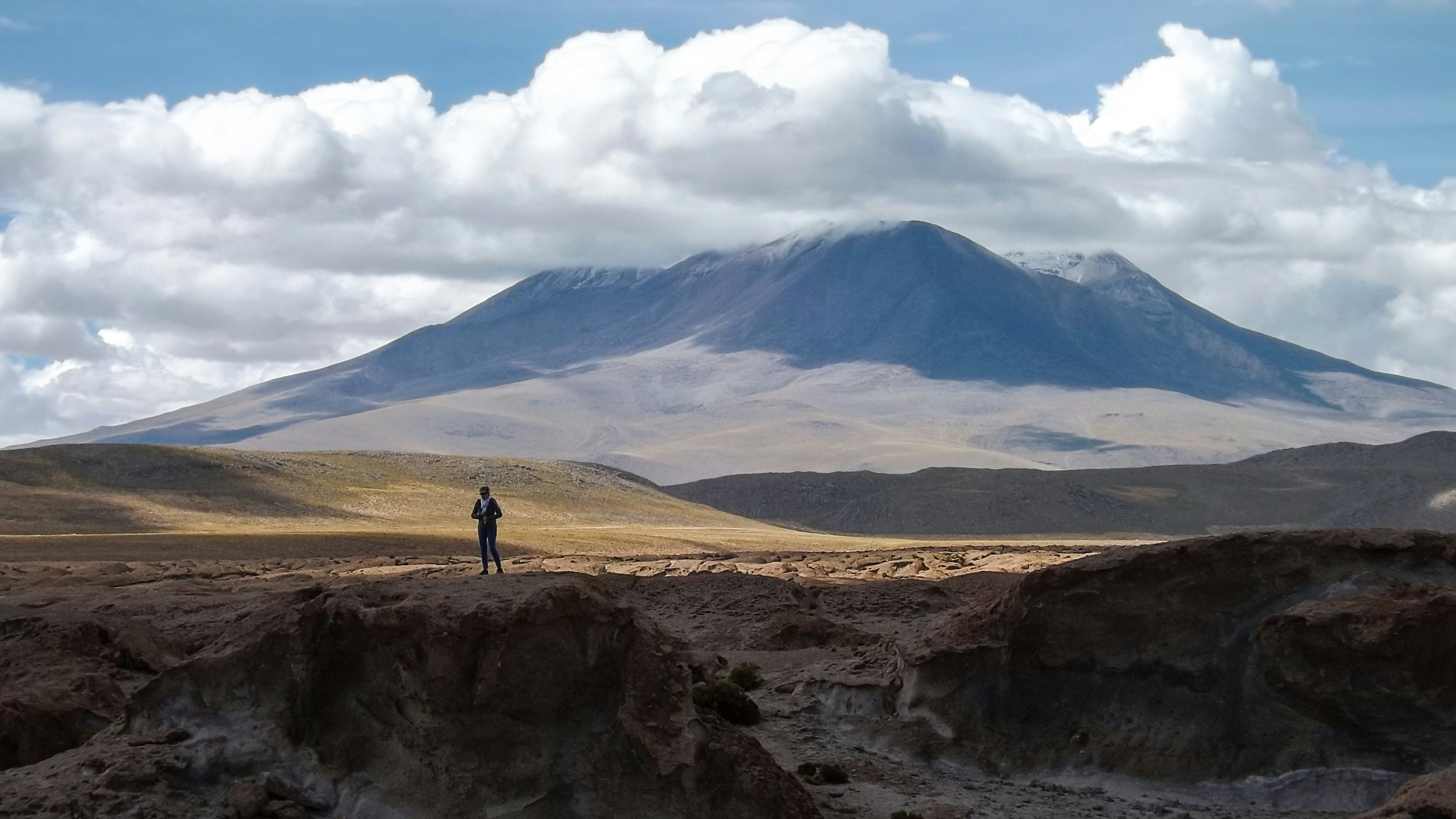 a person standing on a rocky hill