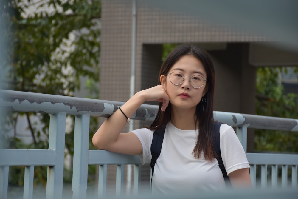 a woman leaning on a railing