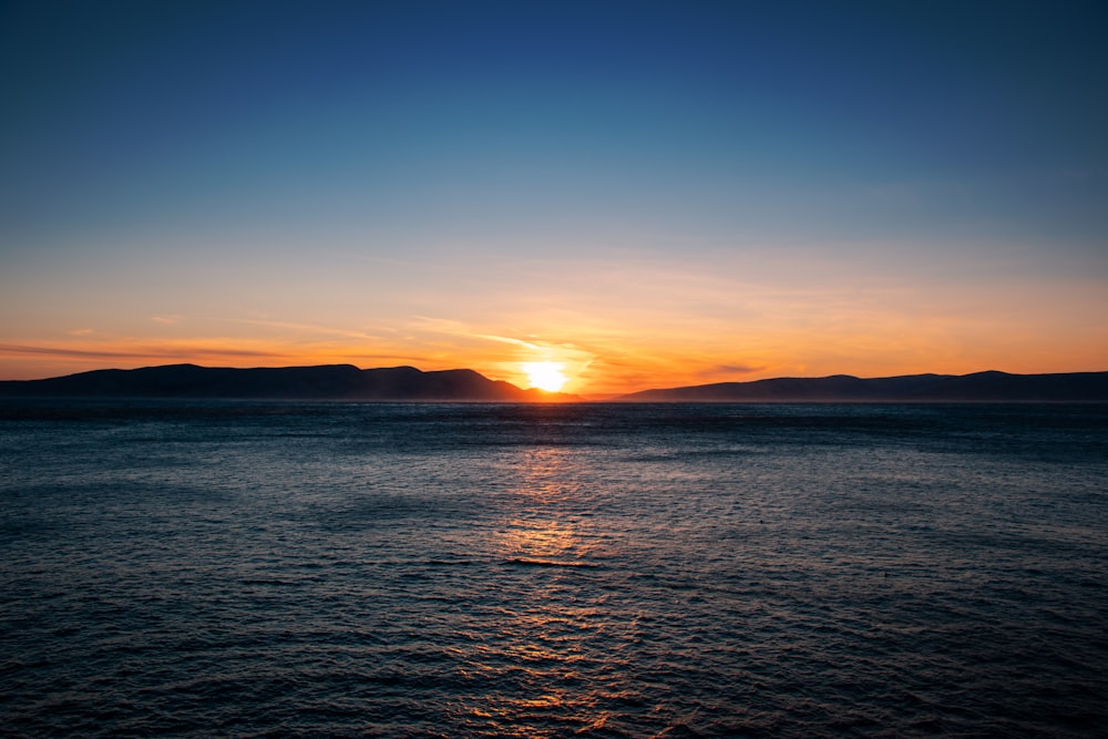 a sunset over a body of water