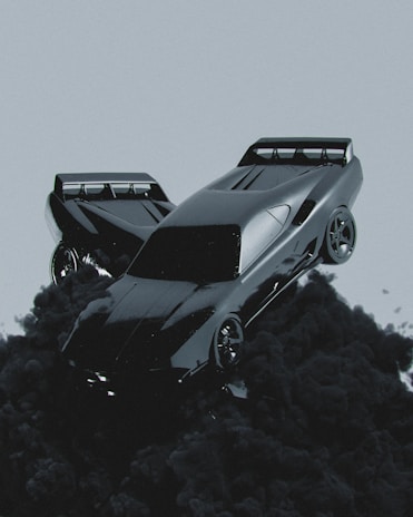 A sleek, futuristic car seems to be floating or emerging from dark, billowing smoke against a muted gray background. The car has a shiny, reflective surface and aerodynamic design, emphasizing speed and modernity.