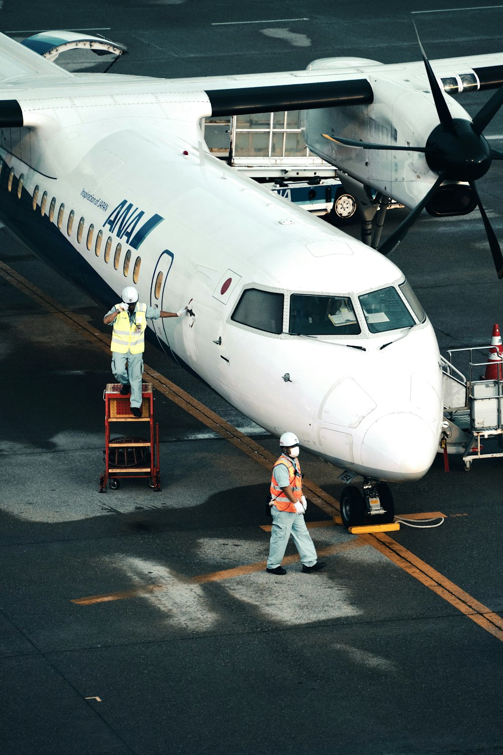 a couple of men working on an airplane