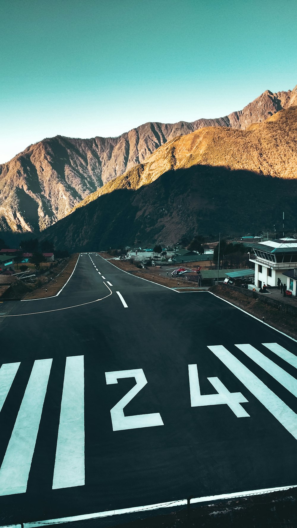 a road with a mountain in the background