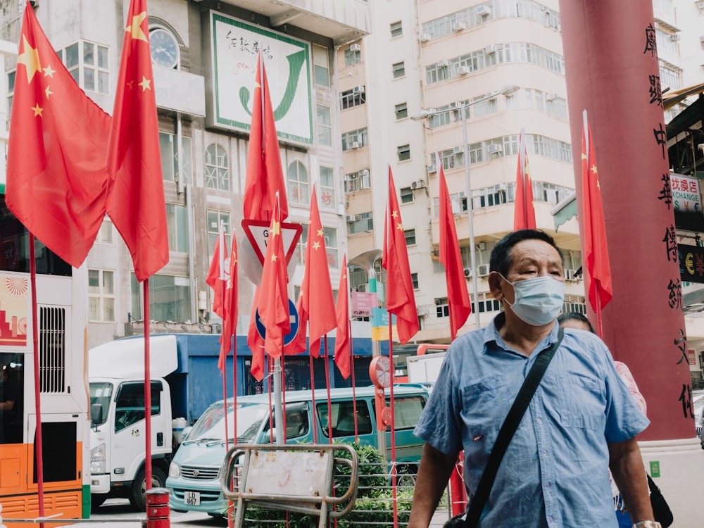 a person wearing a mask and holding a flag