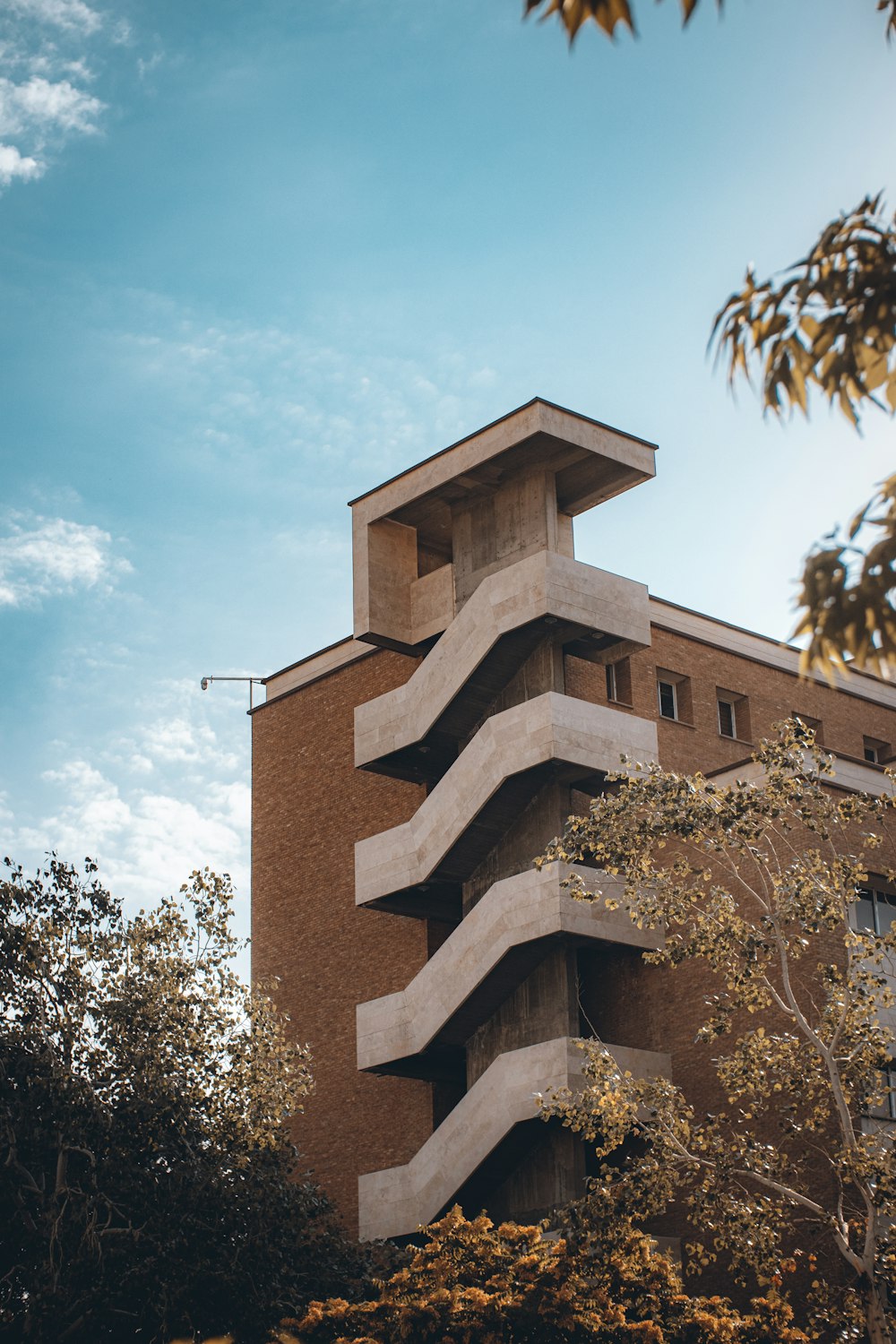 a tall building with trees in front of it