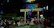 Guests walking along a lively street near Patong Beach with colorful nightlife lights.