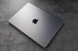 A sleek laptop displaying a completed loan application form.