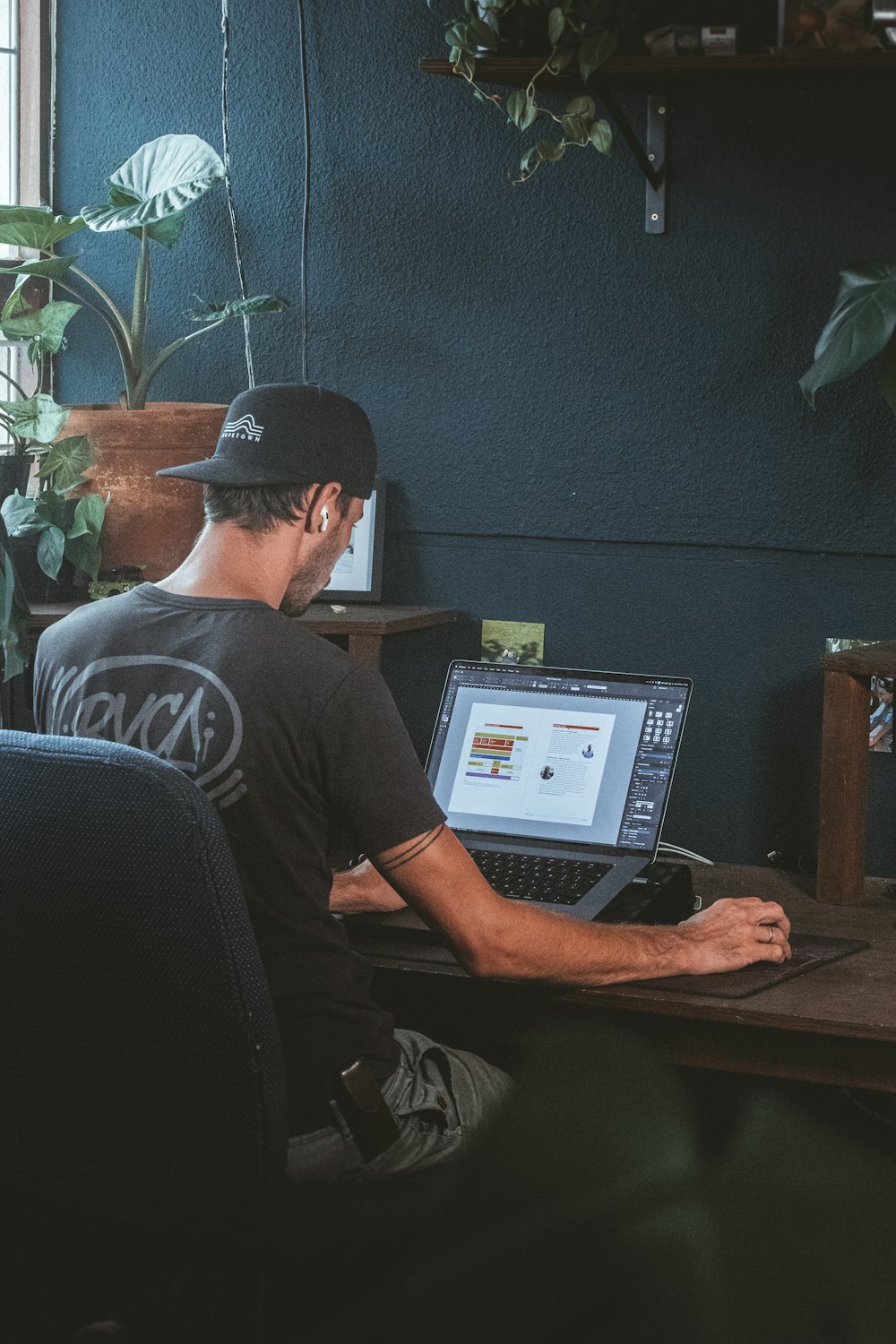 a man sitting at a desk with a laptop