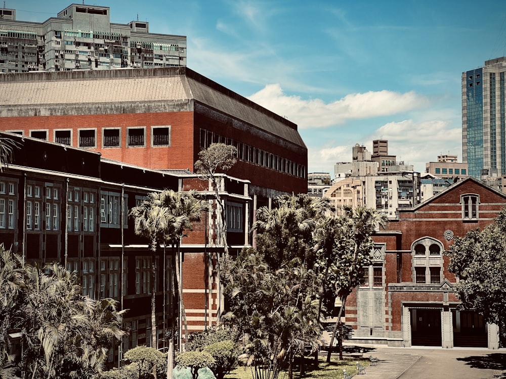 a group of buildings with trees in front of them