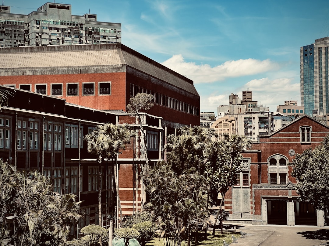 a group of buildings with trees in front of them, Oasis in the urban desert.