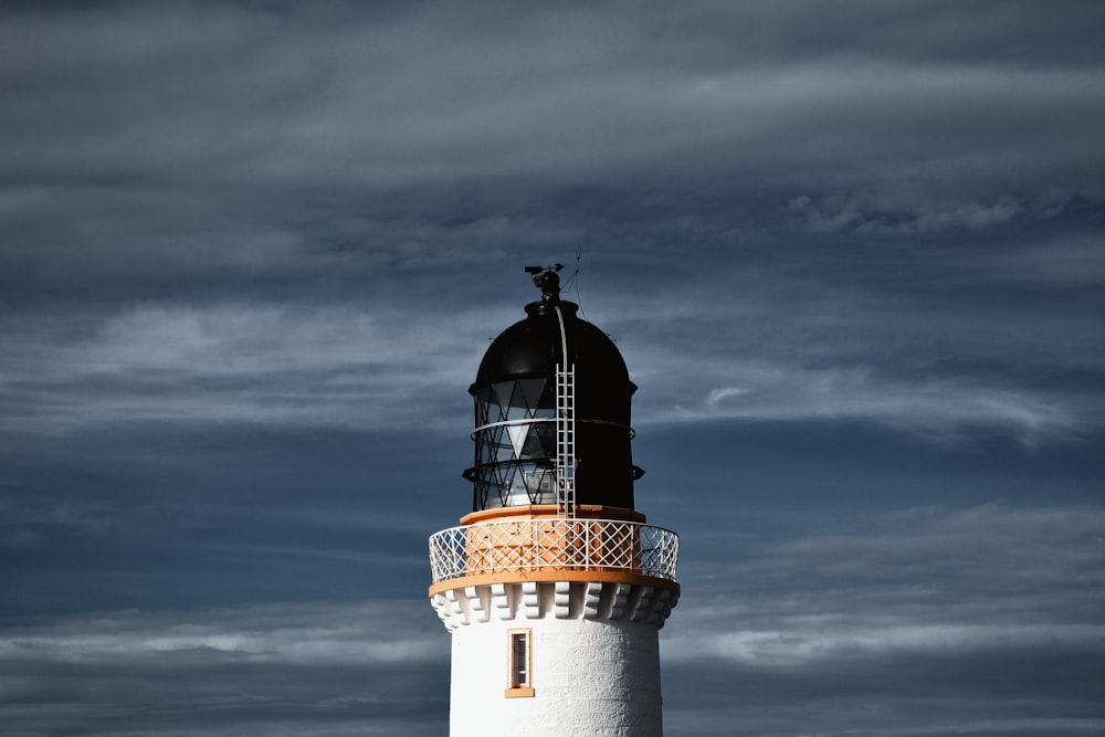 a lighthouse with a cloudy sky