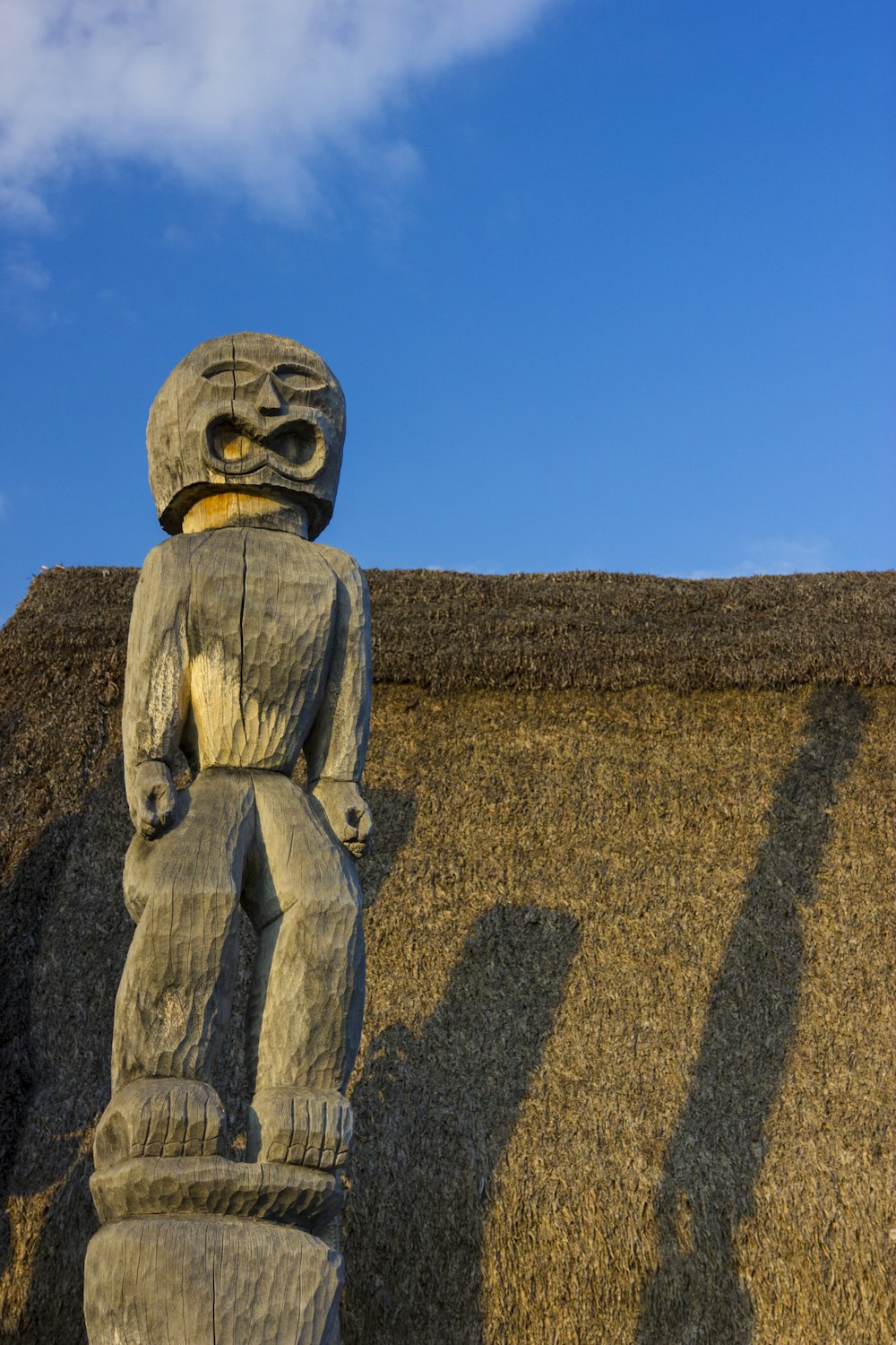 a statue of a person wearing a helmet and a hat