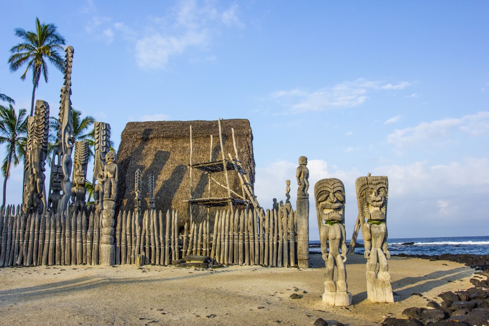 a group of statues on a beach