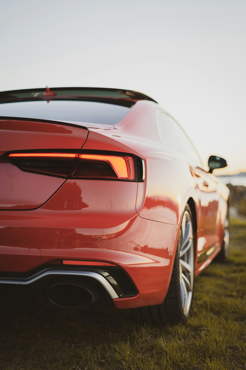 a red sports car parked on grass