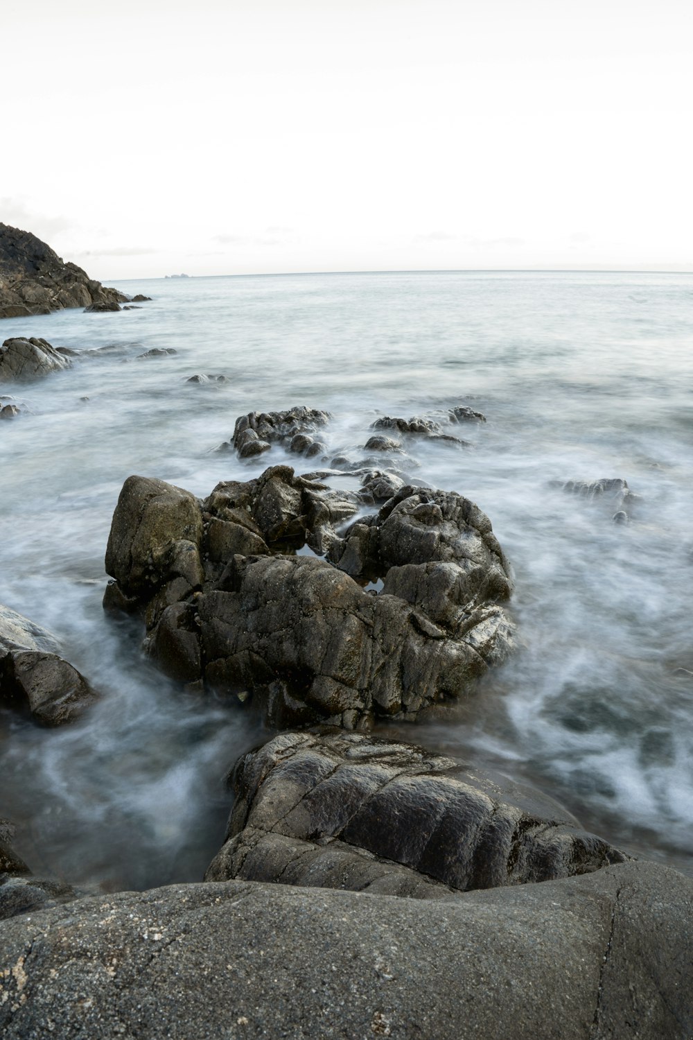 a rocky beach with waves crashing