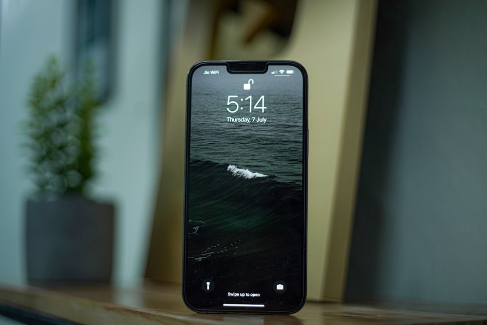 a black smartphone on a table