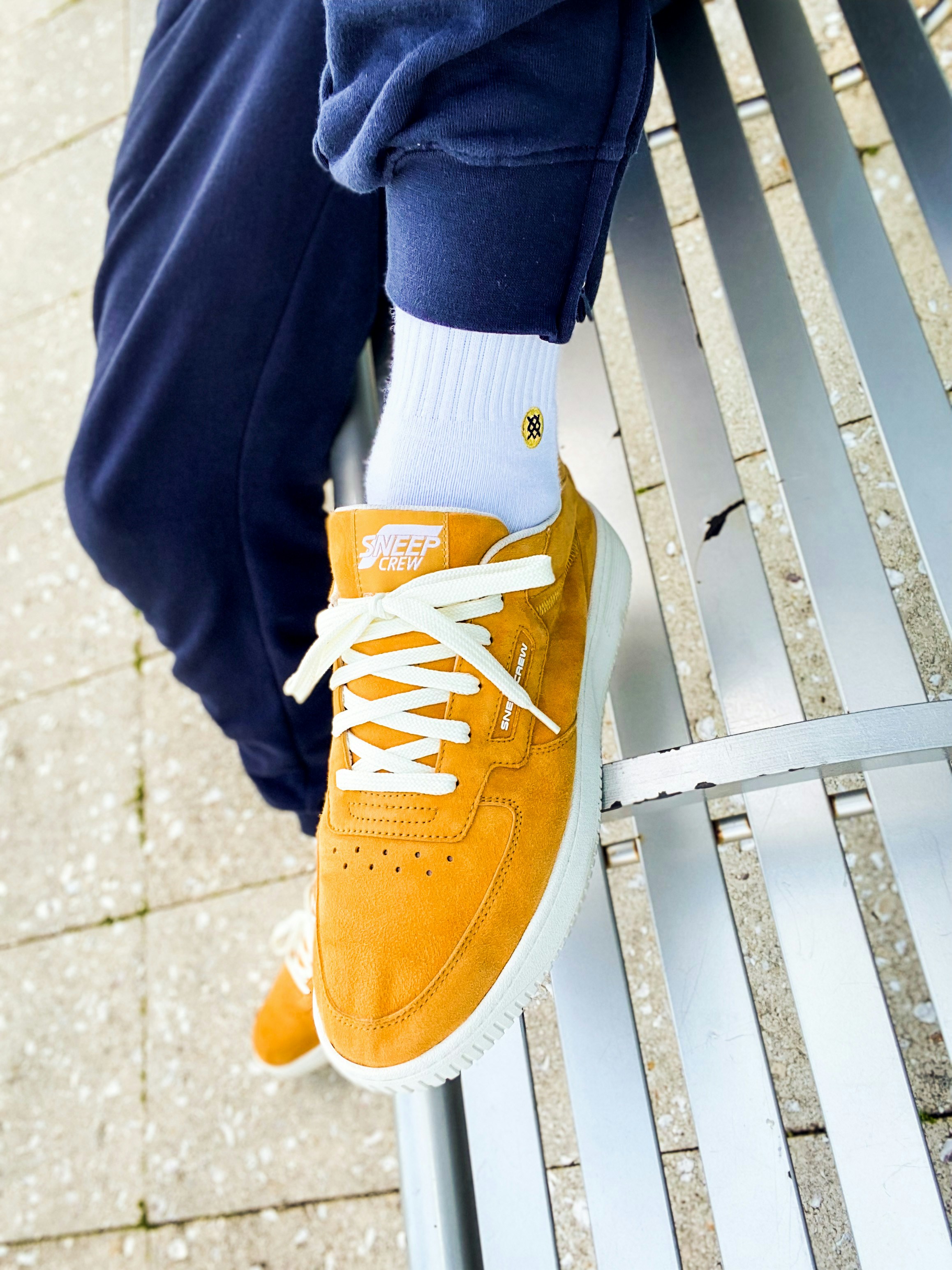 A close-cropped view of a person wearing a casual shoe