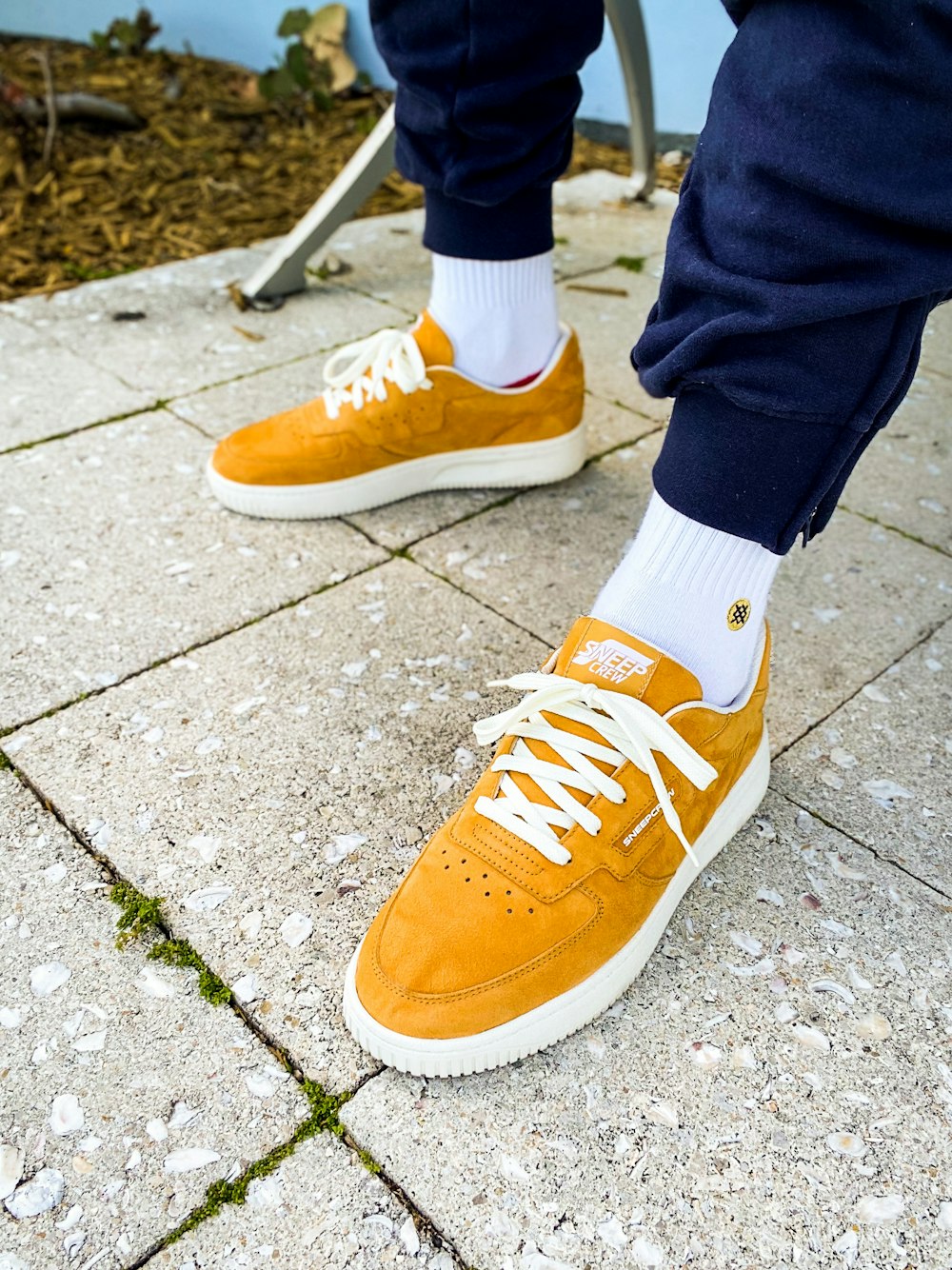A person's feet in orange and white shoes photo – Free Shoe Image on  Unsplash