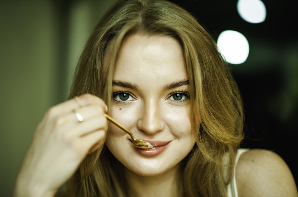 a woman with a spoon in her mouth