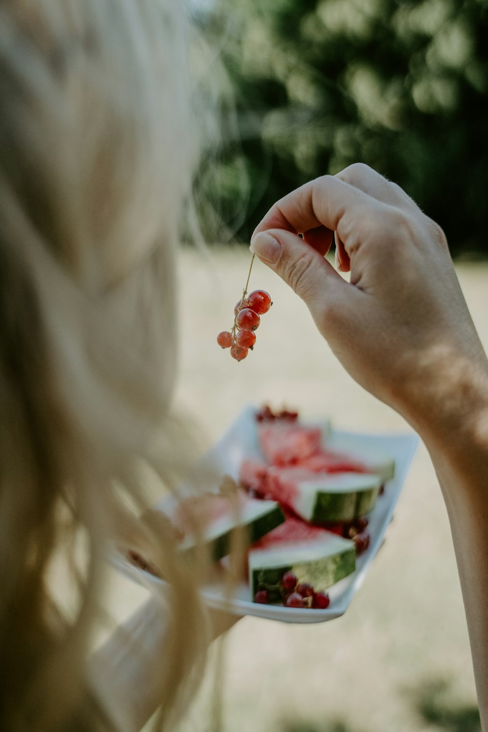 a person holding a small cup of food