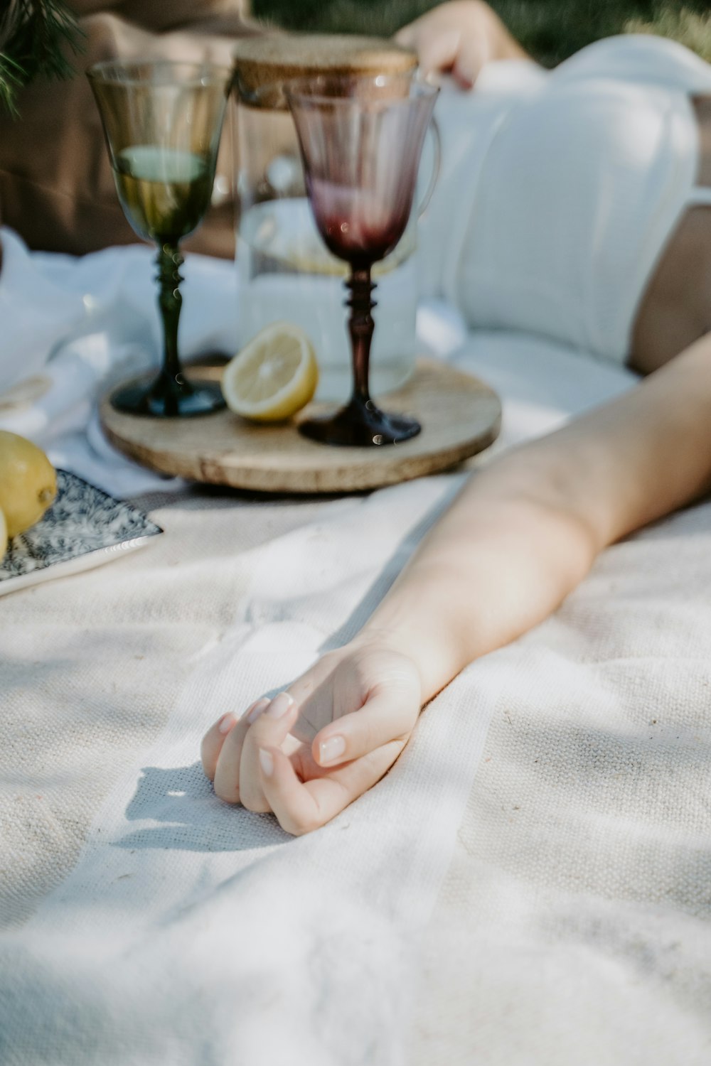 a hand holding a small glass of wine