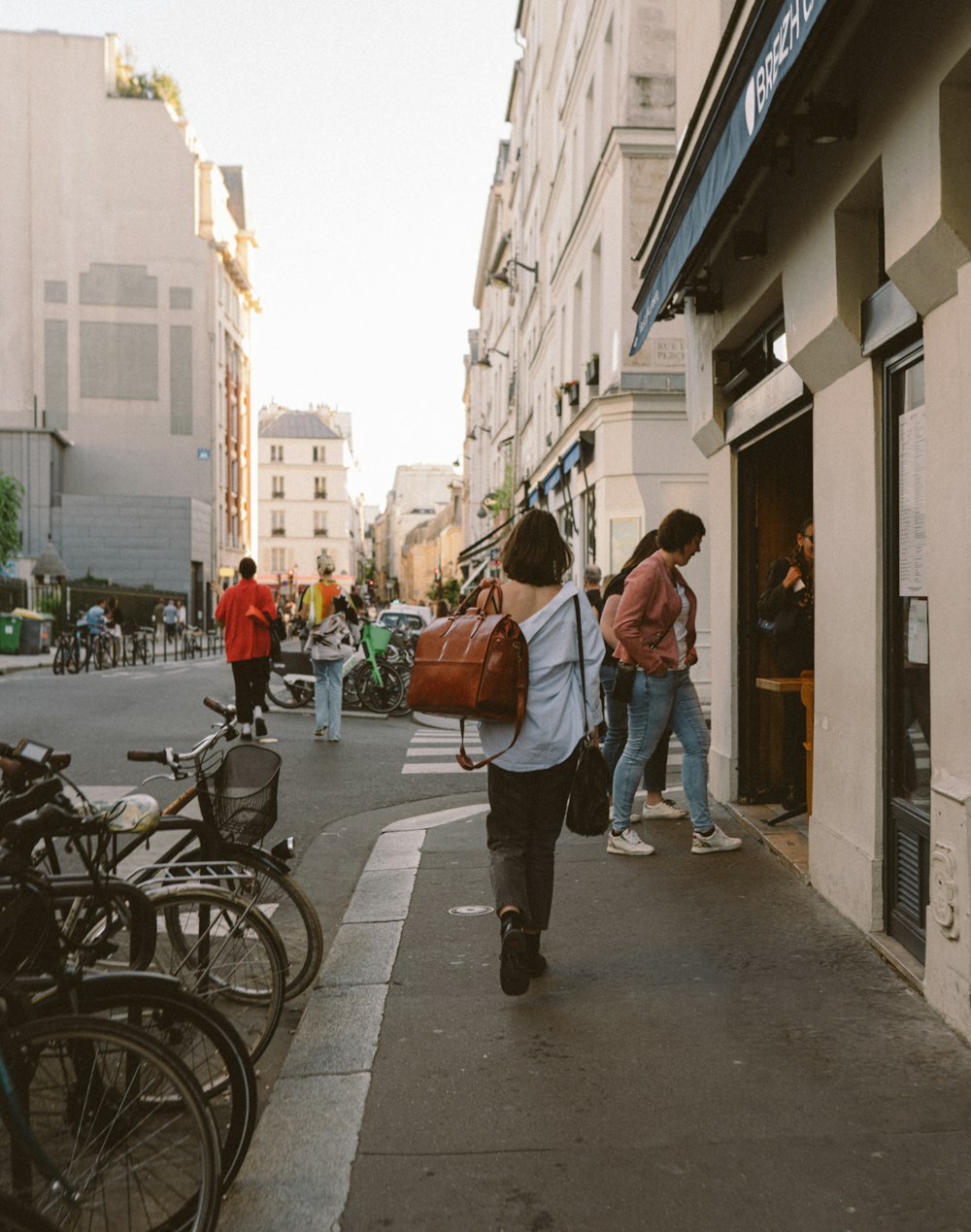 people walking on a sidewalk